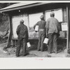 Miners looking at daily reports, checking the number of tons of slate and coal they loaded during their shift. Also to find out whether or not they work the next day. Capels, West Virginia