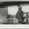 Miner looking at daily reports (company work sheets) checking number of tons of slate he loaded during shift. Also to find out whether or not they work the next day. Capels, West Virginia