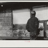 Miner looking at daily reports (company work sheets) checking number of tons of slate he loaded during shift. Also to find out whether or not they work the next day. Capels, West Virginia