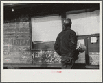 Miner looking at daily reports (company work sheets) checking number of tons of slate he loaded during shift. Also to find out whether or not they work the next day. Capels, West Virginia