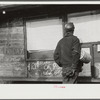 Miner looking at daily reports (company work sheets) checking number of tons of slate he loaded during shift. Also to find out whether or not they work the next day. Capels, West Virginia