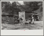 WPA (Works Progress Administration) worker's wife washing clothes in front yard. South Charleston, West Virginia