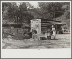 WPA (Works Progress Administration) worker's wife washing clothes in front yard. South Charleston, West Virginia