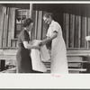 Miss Hesterley, FSA (Farm Security Administration) supervisor, delivers sheeting to Mrs. A.L. Lanier on undeveloped government place. Coffee County, Alabama