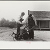 Mr. Ellis Adkins and his son, rural rehabilitation borrowers, examining new cultivator bought with FSA (Farm Security Administration) loan. There are nine in the family and this is their first year on the program. Coffee County, Alabama