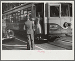 Domestic help boarding streetcar, Atlanta, Georgia