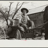 Lee Betties, rural rehabilitation client, with sack of horse and mule feed on rear of his wagon, leaving general store at Woodville, Greene County, Georgia