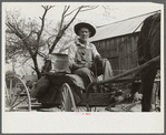 Lee Betties, rural rehabilitation client, with sack of horse and mule feed on rear of his wagon, leaving general store at Woodville, Greene County, Georgia