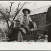 Lee Betties, rural rehabilitation client, with sack of horse and mule feed on rear of his wagon, leaving general store at Woodville, Greene County, Georgia