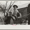 Lee Betties, rural rehabilitation client, with sack of horse and mule feed on rear of his wagon, leaving general store at Woodville, Greene County, Georgia