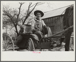 Lee Betties, rural rehabilitation client, with sack of horse and mule feed on rear of his wagon, leaving general store at Woodville, Greene County, Georgia