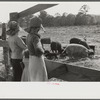 Part of George Cowley's family (rural rehabilitation), looking over pigs in sty. Pike County, Alabama