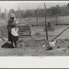 Charles McGuire's wife and baby looking at their new poultry yard and pen with biddies. Tenant purchase clients. Pike County, Alabama