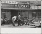 Farmer looking at new equipment. Saturday afternoon, Enterprise, Alabama