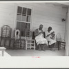 Jorena Pettway and her daughter making chair cover out of bleached flour sacks and flower decorations from paper. She also made the chairs and practically all the furniture in the house. Gees Bend, Alabama
