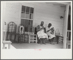 Jorena Pettway and her daughter making chair cover out of bleached flour sacks and flower decorations from paper. She also made the chairs and practically all the furniture in the house. Gees Bend, Alabama