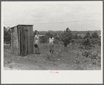 FSA (Farm Security Administration) home management supervisor pointing out to rehabilitation borrower where new privy will be located. Greene County, Georgia