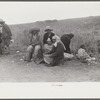 Vegetable pickers, migrants, waiting after work to be paid. Near Homestead, Florida