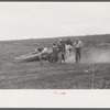 Vegetable pickers, migrants, waiting after work to be paid. Near Homestead, Florida