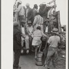 Vegetable workers, migrants, waiting after work to be paid. Near Homestead, Florida