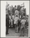 Vegetable workers, migrants, waiting after work to be paid. Near Homestead, Florida
