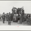 Vegetable workers, migrants, waiting after work to be paid. Near Homestead, Florida
