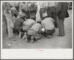 Vegetable workers, migrants, waiting after work to be paid. Near Homestead, Florida