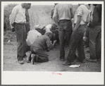 Vegetable workers, migrants, waiting after work to be paid. Near Homestead, Florida