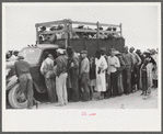 Vegetable workers, migrants, waiting after work to be paid. Near Homestead, Florida
