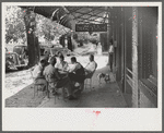 Playing dominoes or cards in front of drug store in center of town, in Mississippi Delta, Mississippi