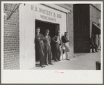 Men standing around outside general store, Wendell, Wake County, North Carolina