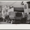 Farmers bringing tobacco to warehouse in trailers, on top of their cars, and even inside their cars for auction. Durham, North Carolina