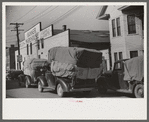 Farmers bringing tobacco to warehouse in trailers, on top of their cars, and even inside their cars for auction. Durham, North Carolina