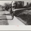 Mr. Elvin Wilkins with butter he is selling which was made on his farm. Durham, North Carolina