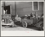 Farmers and warehousemen unloading tobacco on sidewalk before auction sales. The warehouse was too overloaded to permit more tobacco being brought in. Mebane County, North Carolina