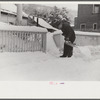 Clearing off the sidewalk after the snowstorm in front of White Cupboard Inn, Woodstock, Vermont