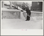 Clearing off the sidewalk after the snowstorm in front of White Cupboard Inn, Woodstock, Vermont