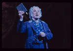 George Rose [clutching book medium shot] in the stage production The Mystery of Edwin Drood