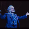 George Rose [arms spread]  in the stage production The Mystery of Edwin Drood
