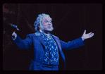 George Rose [arms spread]  in the stage production The Mystery of Edwin Drood