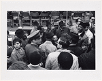 Surrounded by supporters, advisors, and security personnel, Dr. King prepares for his speech at the United Nations on April 15, 1967. At left is NBC correspondent Ponchita Pierce