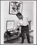 Baldwin turning knob on record player, 1963