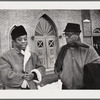Baldwin, left, with brother David in front of church