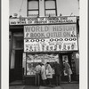 Baldwin and others looking in display window of African National Memorial Bookstore