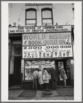 Baldwin and others looking in display window of African National Memorial Bookstore
