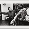 Baldwin dancing behind Doris Castle, arms raised