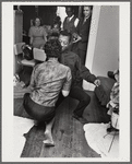 Baldwin dancing with Doris Castle, low to floor and appearing to do "the Twist"