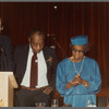 Baldwin standing with mother, Emma Berdis Jones Baldwin, next to podium at his 60th birthday celebration, UMass Campus Center