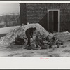 Hired hand on Mr. Dickinson's farm, splitting logs for winter fuel. Lisbon, near Franconia, New Hampshire
