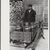 Hauling water in milk cans because usual source of supply is frozen. Putney Homestead farm near Woodstock, Vermont